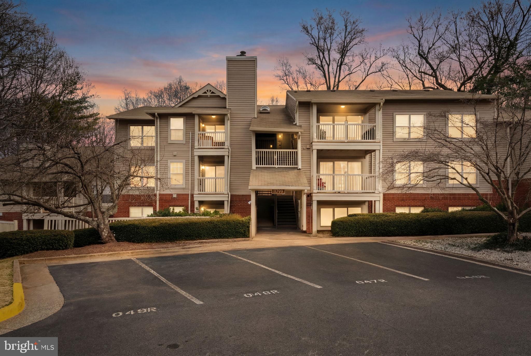 11703 Olde English Drive, Unit B Reston, VA 20190 - Photo 2 of 32 a front view of a house with a garden