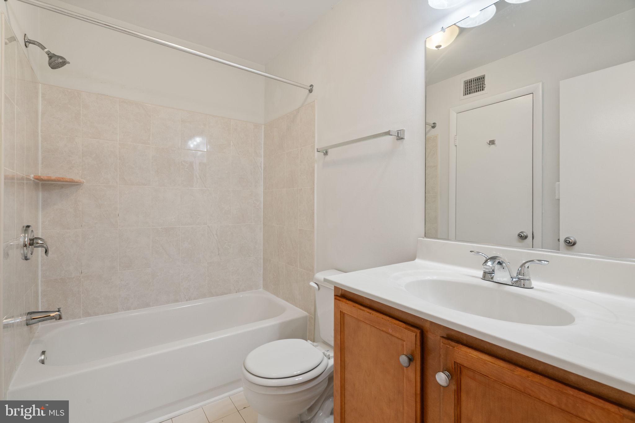 11703 Olde English Drive, Unit B Reston, VA 20190 - Photo 26 of 32 a bathroom with a sink toilet and shower