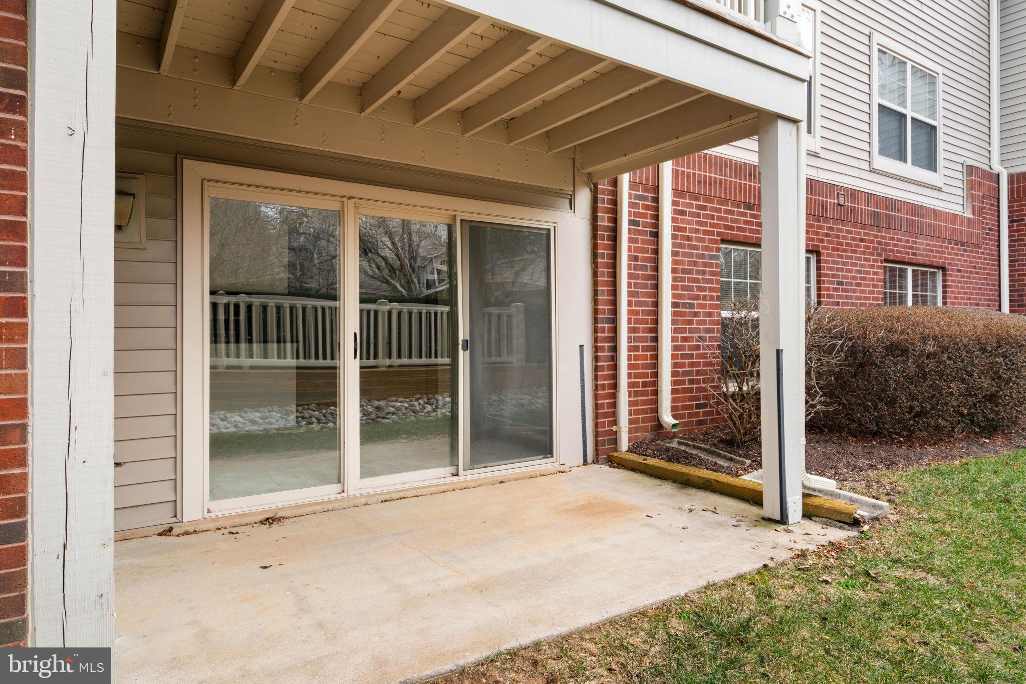 11703 Olde English Drive, Unit B Reston, VA 20190 - Photo 30 of 32 a view of a house with a large window and wooden fence