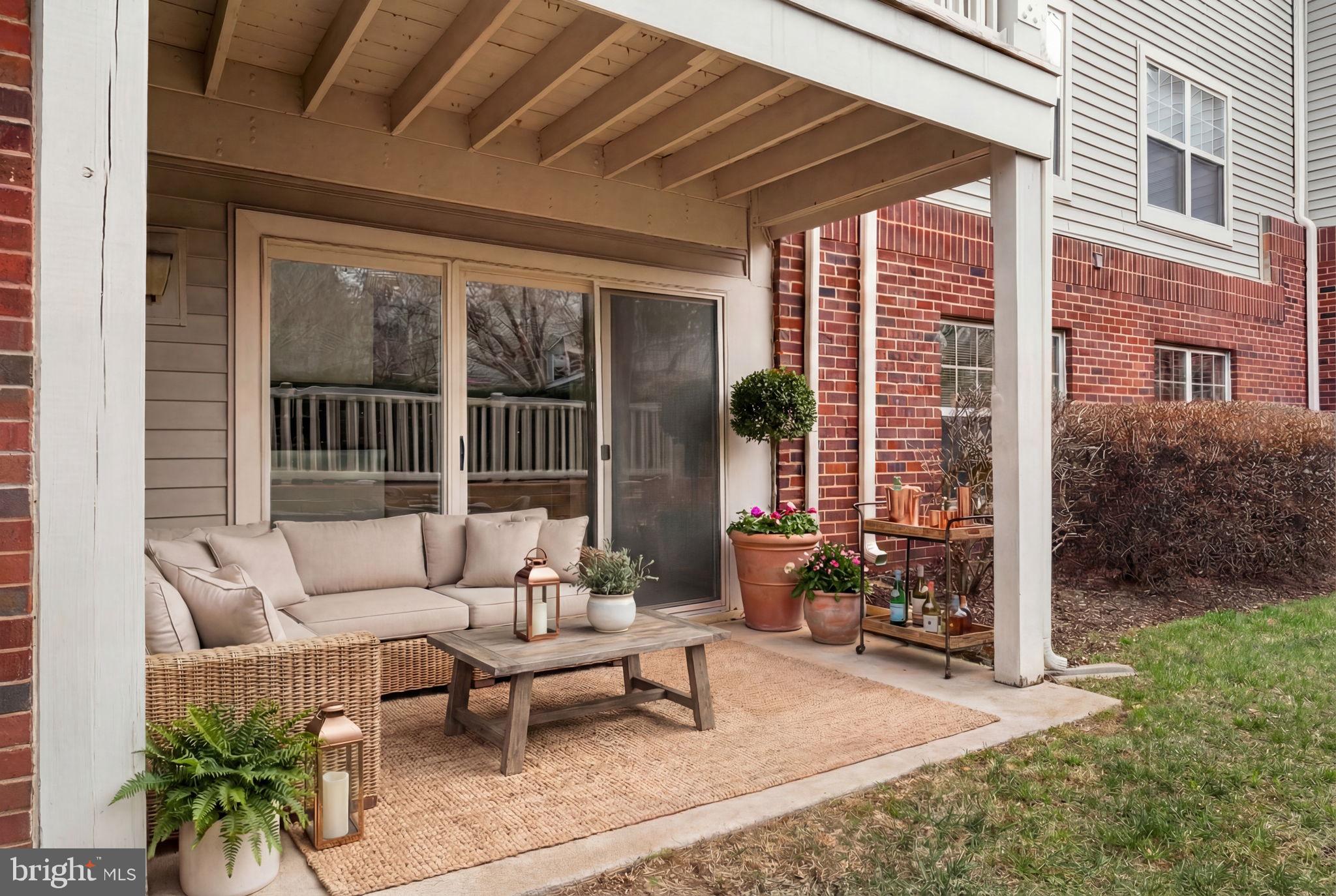 11703 Olde English Drive, Unit B Reston, VA 20190 - Photo 31 of 32 a building outdoor space with patio furniture and potted plants