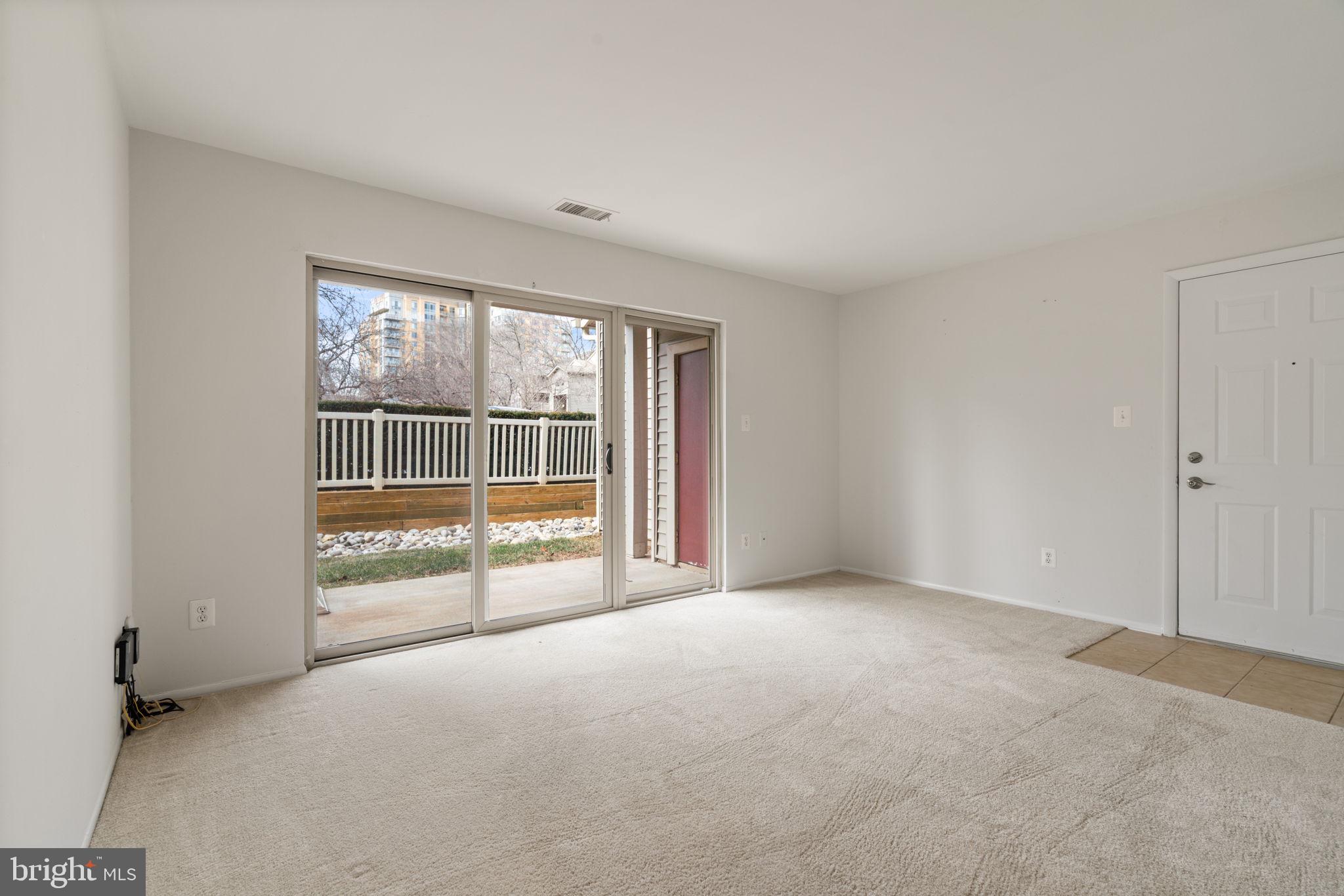11703 Olde English Drive, Unit B Reston, VA 20190 - Photo 5 of 32 an empty room with floor to ceiling windows