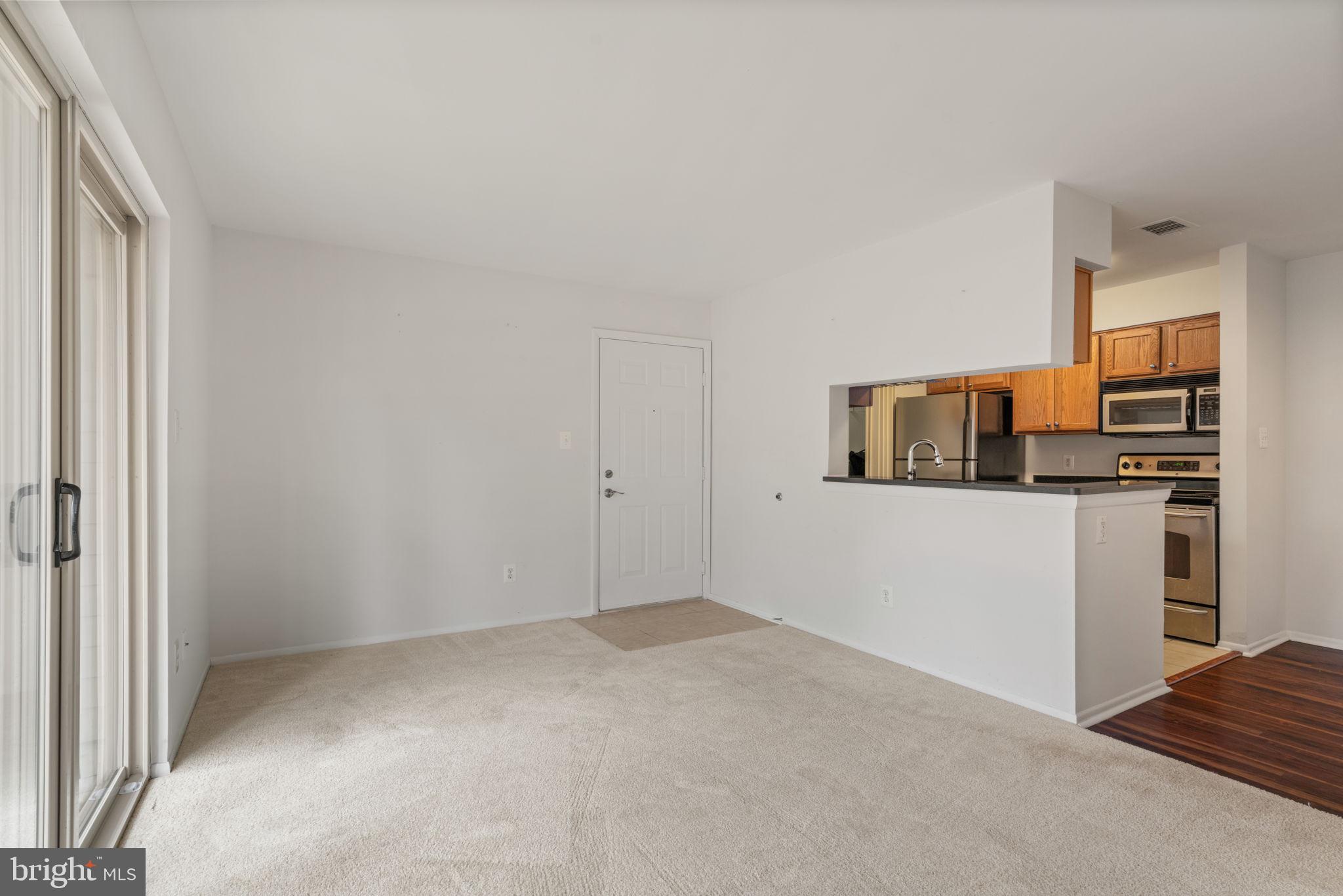 11703 Olde English Drive, Unit B Reston, VA 20190 - Photo 7 of 32 a view of a kitchen and an empty room