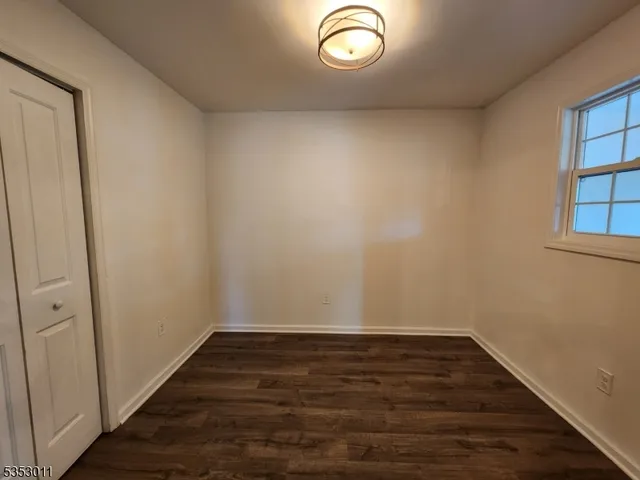 a view of room with wooden floor