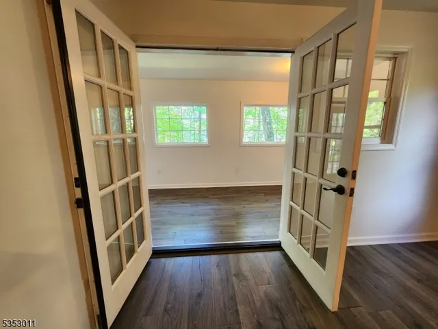 a view of an entryway with wooden floor and stairs
