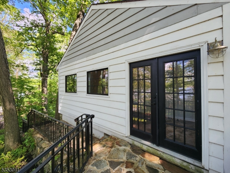 7 Raccoon Island Road Lake Hopatcong, NJ 07849 - Photo 16 of 24 a porch with a table and chairs and potted plants