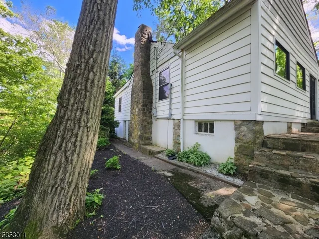 a backyard of a house with lots of green space and lake view