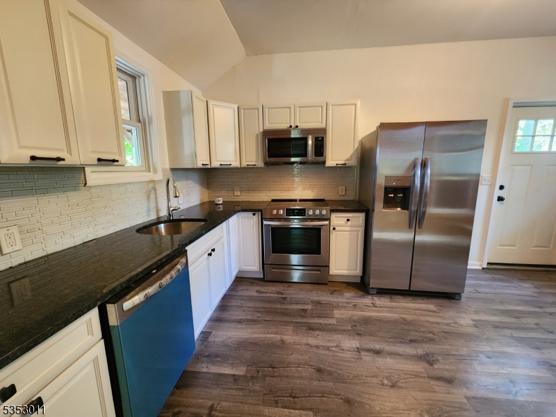 7 Raccoon Island Road Lake Hopatcong, NJ 07849 - Photo 7 of 24 a large kitchen with stainless steel appliances granite countertop a stove a sink and a refrigerator
