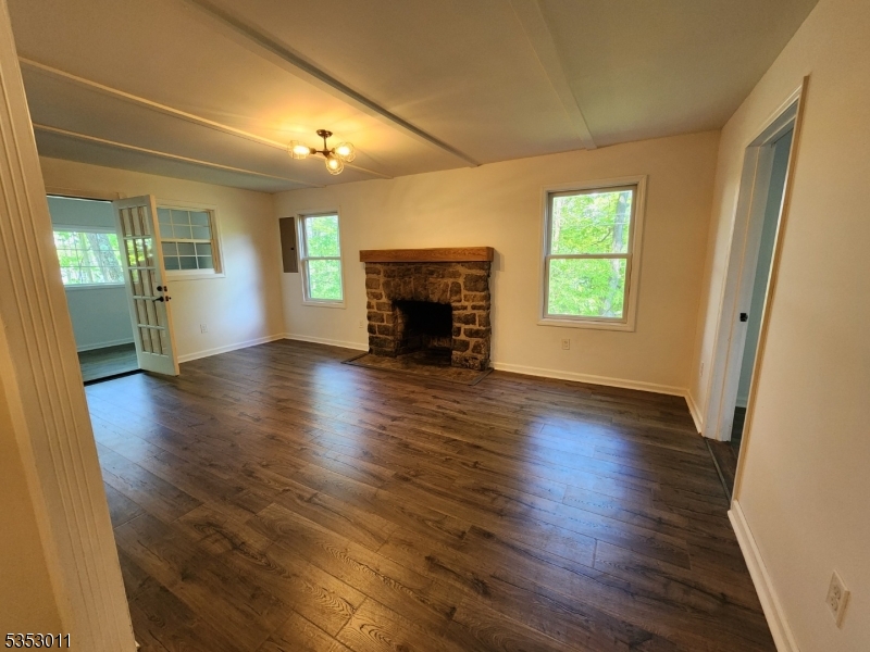 7 Raccoon Island Road Lake Hopatcong, NJ 07849 - Photo 10 of 24 an empty room with wooden floor fireplace and windows