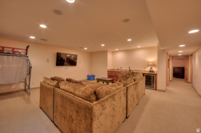 425 Amber Lane Moab, UT 84532 - Photo 19 of 27 Living room featuring bar with sink, recessed lighting, beverage cooler, and light colored carpet