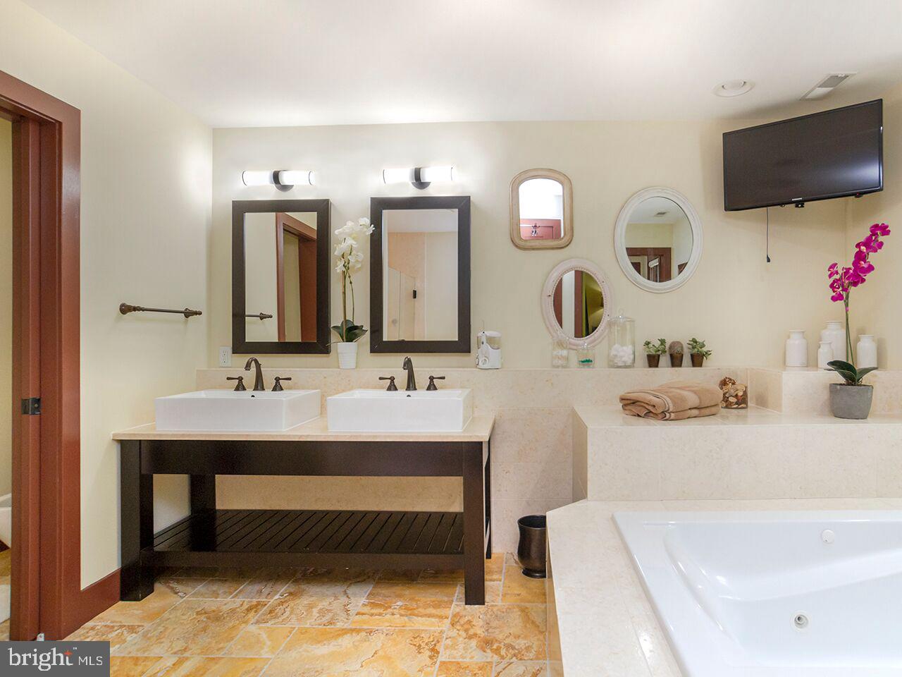 930 Corbett Road Monkton, MD 21111 - Photo 39 of 102 a bathroom with a tub sink and mirror