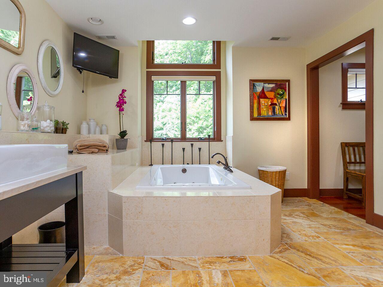930 Corbett Road Monkton, MD 21111 - Photo 40 of 102 a spacious bathroom with a granite countertop sink a mirror and a bathtub