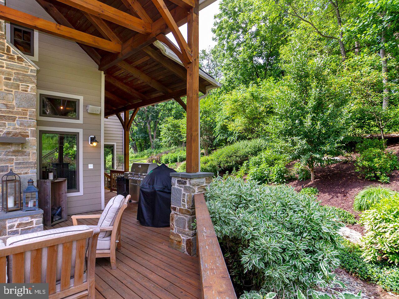 930 Corbett Road Monkton, MD 21111 - Photo 72 of 102 a view of a patio with table and chairs potted plants and floor to ceiling window