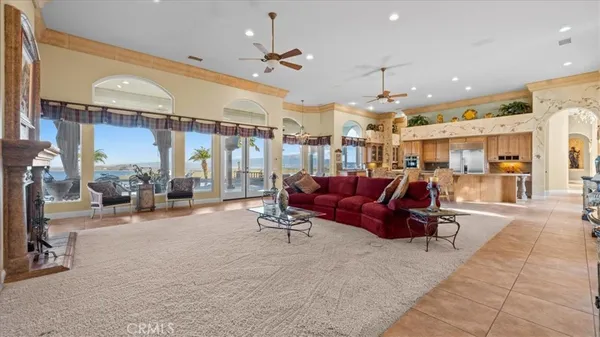 a living room with furniture a bookshelf and a window