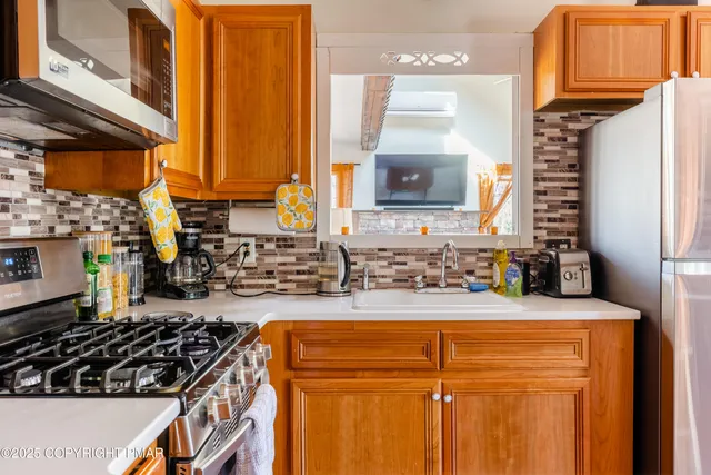 a kitchen with a sink a stove and cabinets