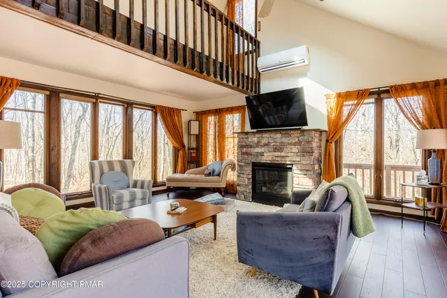 a living room with furniture fireplace and flat screen tv