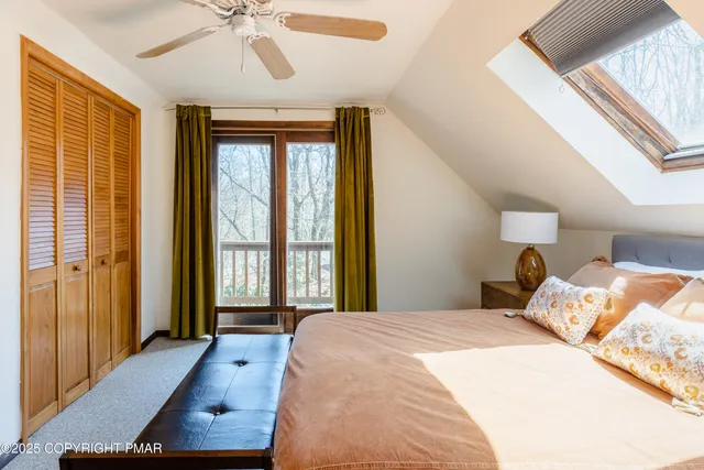 a bedroom with a large bed and a window