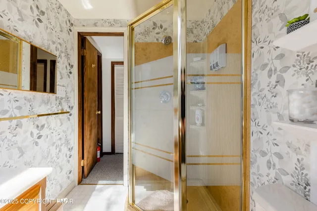 a bathroom with a shower and a glass door