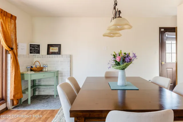 a dining room with furniture and wooden floor