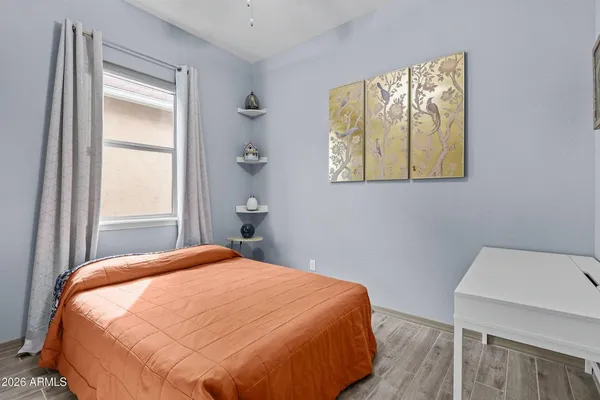 a bedroom with a bed and a window