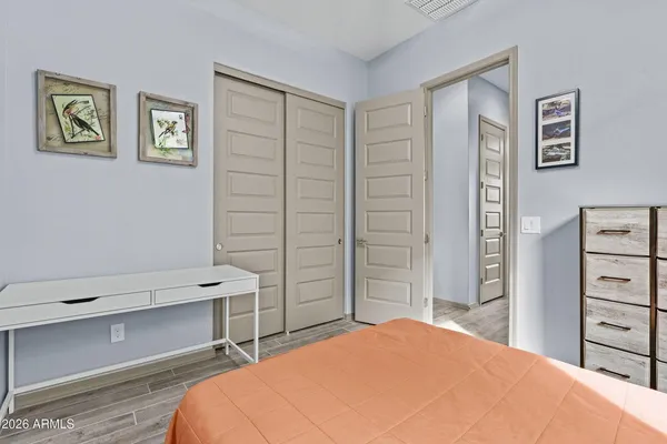 a bedroom with a bed and a desk