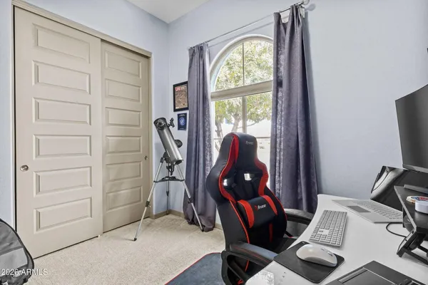 a view of a workspace with furniture and a window