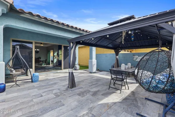 a patio with a table and chairs