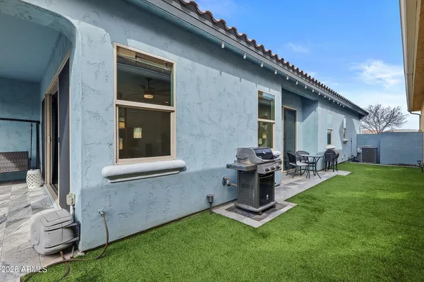 a view of backyard with a barbeque grill and outdoor seating