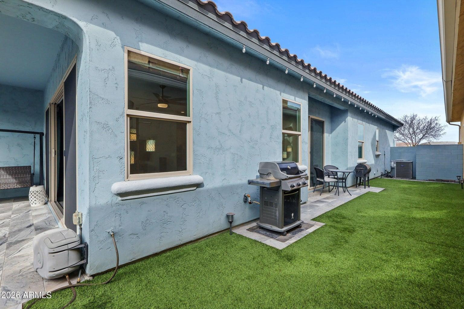 4451 East Bernice Street Gilbert, AZ 85295 - Photo 27 of 32 a view of backyard with a barbeque grill and outdoor seating