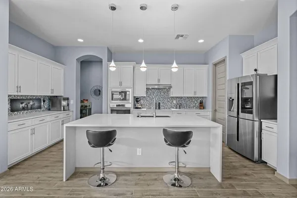 a kitchen with kitchen island a appliances a counter space and a dining table