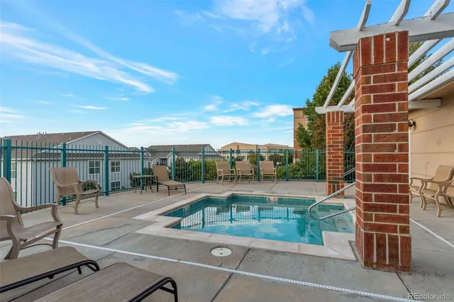 a view of a patio with a table and chairs