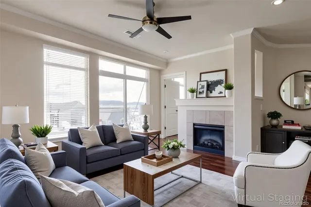 a living room with furniture a fireplace and a large window