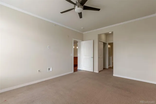 an empty room with closet and windows