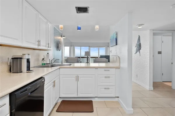a kitchen with stainless steel appliances granite countertop a refrigerator and sink