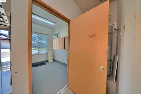 a view of a livingroom with a ceiling fan and window