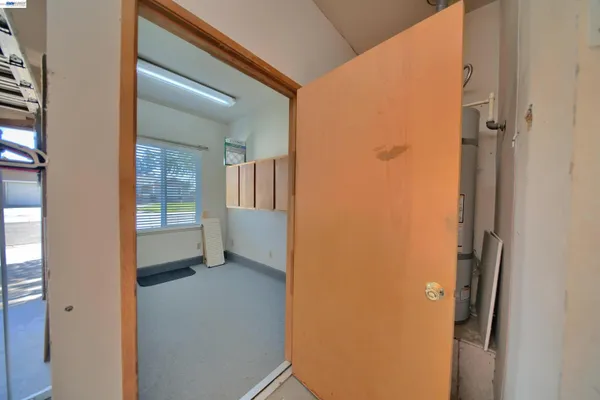 a view of a livingroom with a ceiling fan and window