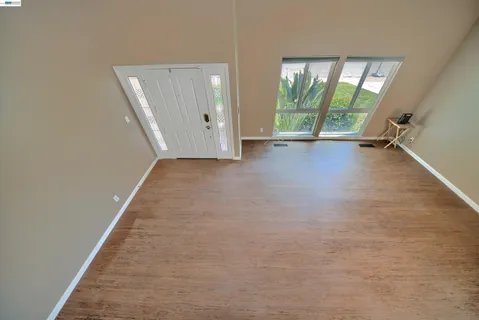 wooden floor in a room with a bathroom