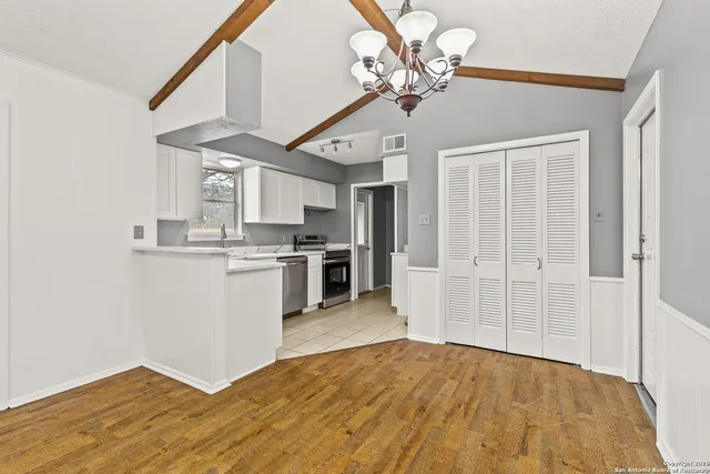 a view of kitchen with sink and refrigerator