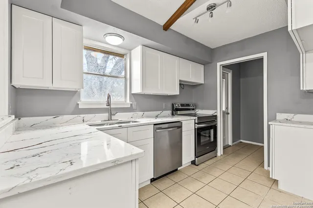 a kitchen with a stove a sink and a refrigerator