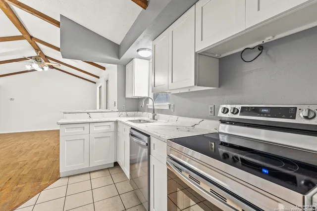a kitchen with appliances cabinets and a sink