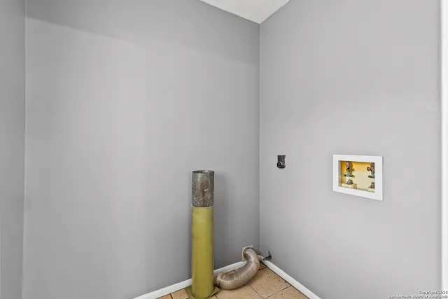 a view of storage and utility room with a window