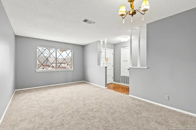 a view of an empty room with a window