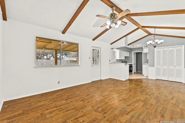 a view of a livingroom with a ceiling fan and window