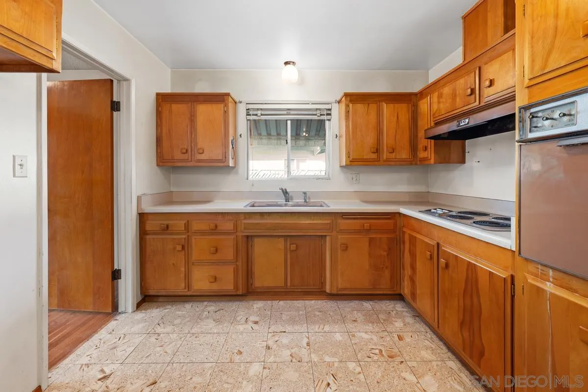 1119 Buckskin Road El Cajon, CA 92019 - Photo 11 of 27 a kitchen with stainless steel appliances granite countertop a sink stove and cabinets