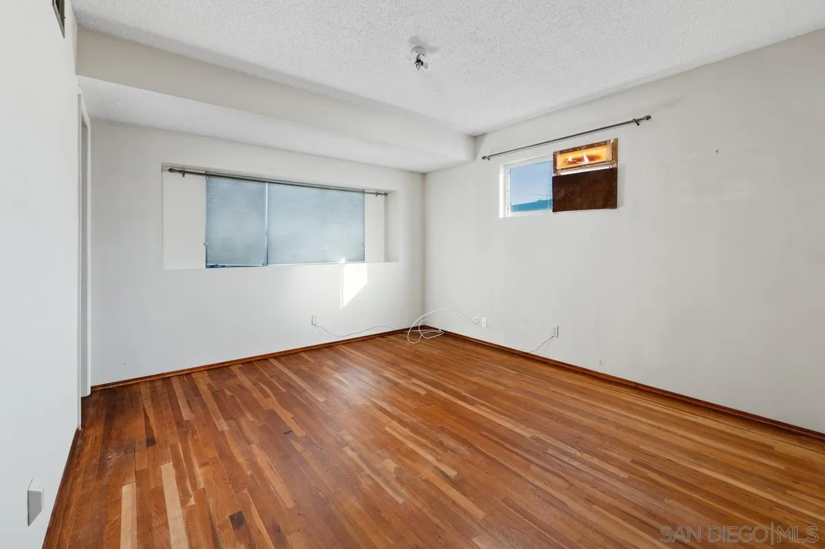 1119 Buckskin Road El Cajon, CA 92019 - Photo 15 of 27 a view of an empty room with wooden floor and a window