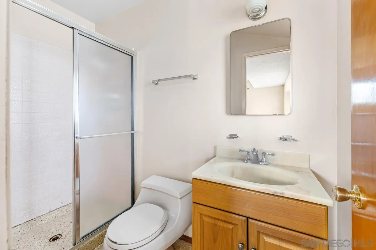 1119 Buckskin Road El Cajon, CA 92019 - Photo 17 of 27 a bathroom with a toilet sink vanity shower and mirror