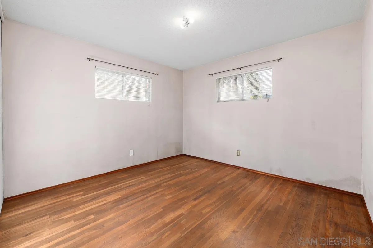 1119 Buckskin Road El Cajon, CA 92019 - Photo 18 of 27 a view of an empty room with wooden floor and a window