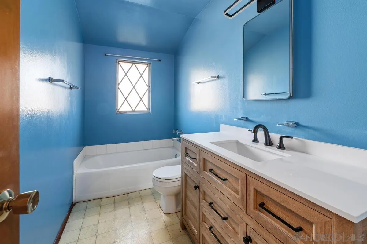 1119 Buckskin Road El Cajon, CA 92019 - Photo 20 of 27 a bathroom with a granite countertop sink toilet a mirror and bathtub
