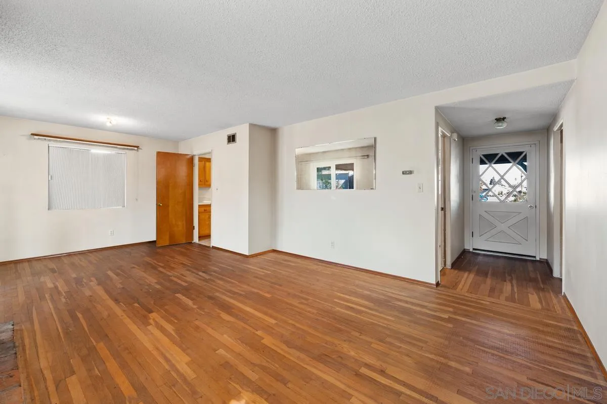 1119 Buckskin Road El Cajon, CA 92019 - Photo 7 of 27 a view of an empty room with wooden floor and a window