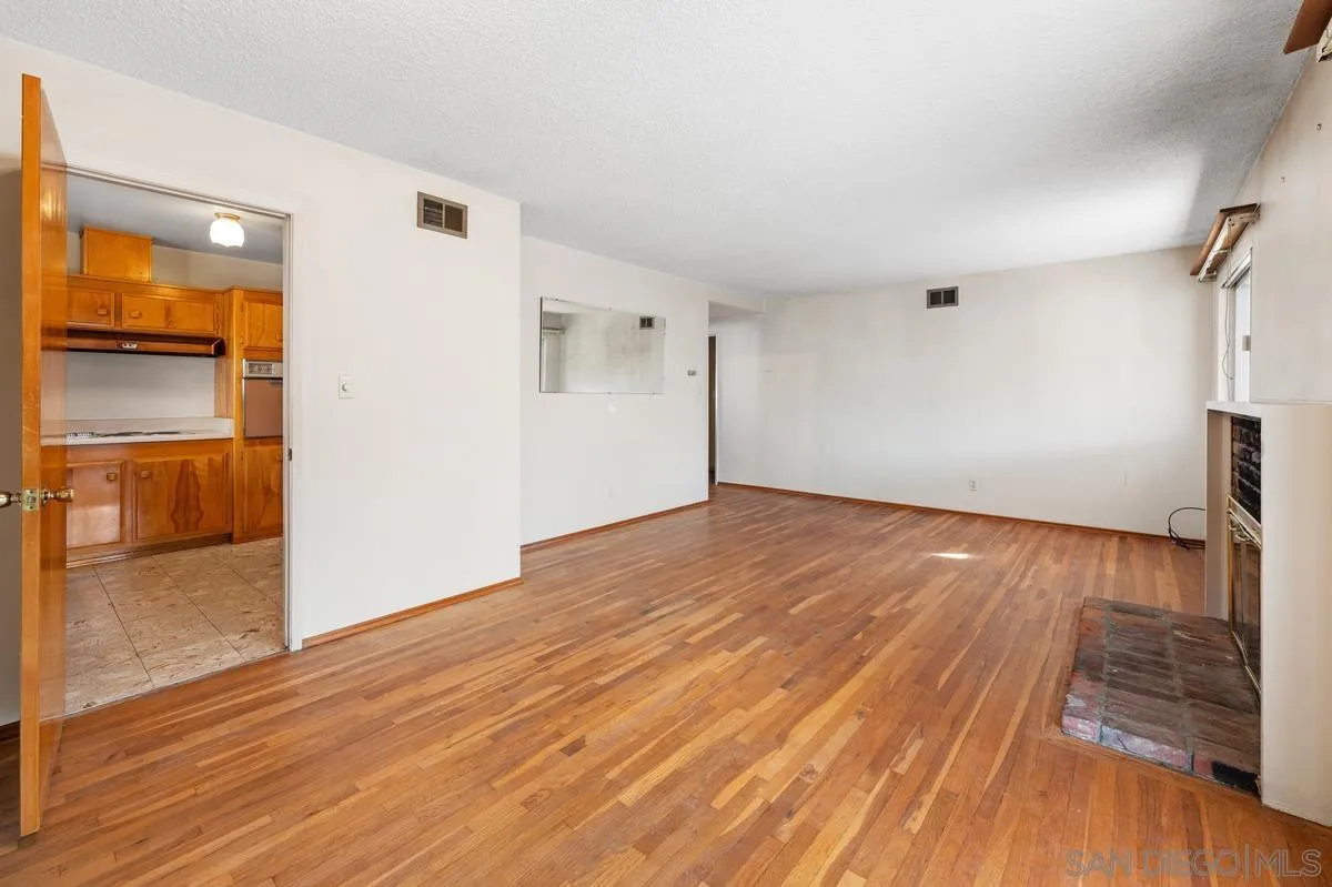 1119 Buckskin Road El Cajon, CA 92019 - Photo 9 of 27 a view of empty room with wooden floor and window