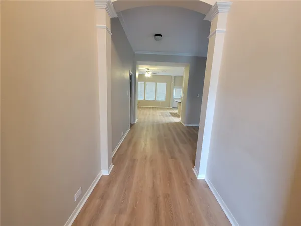a view of a hallway with wooden floor